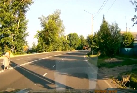 Bon conducteur aide une dame à traverser la route